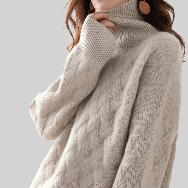 Beige turtleneck sweater worn by a person on a light gray background