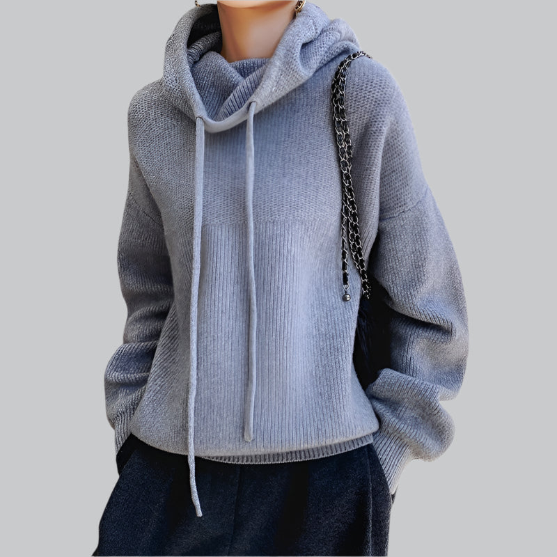 Light blue hoodie worn by a person on a gray background