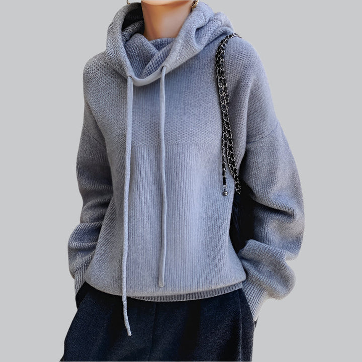 Light blue hoodie worn by a person on a gray background