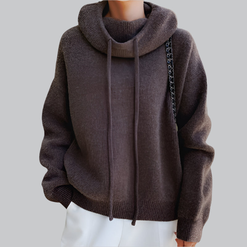 Brown hoodie worn by a person on a light gray background