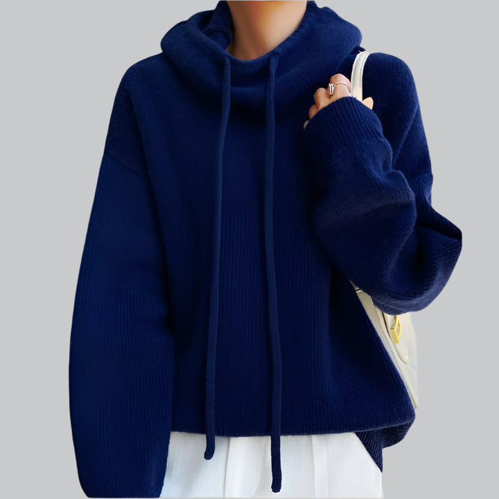 Navy blue sweater worn by a mannequin on a gray background